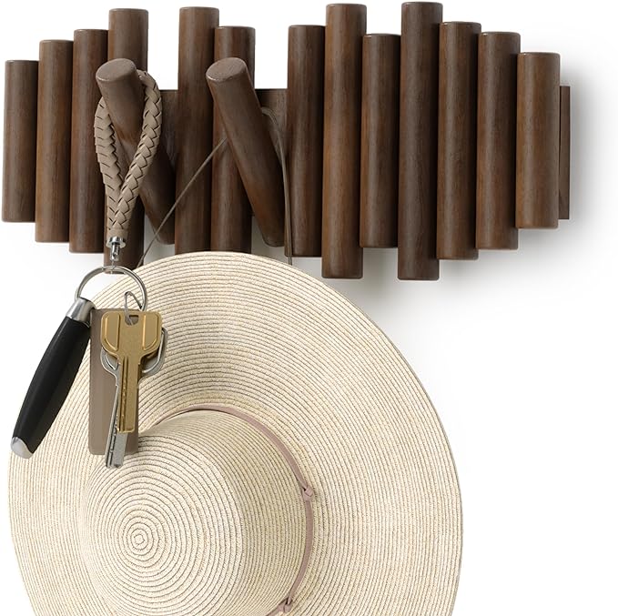 A wooden rack with hook organizers holding a hat and key, providing a convenient storage solution for everyday items.