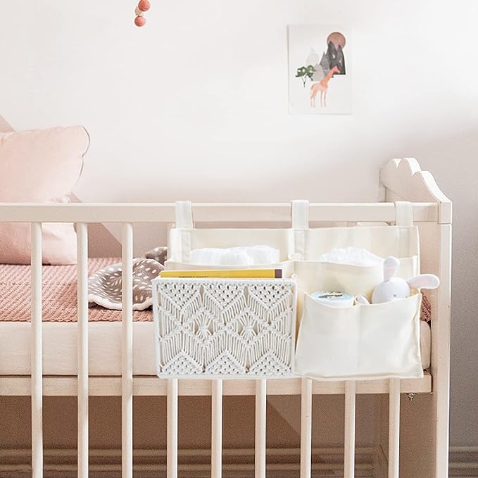 A white cotton hanging organizer on a baby crib in a room with pink walls.