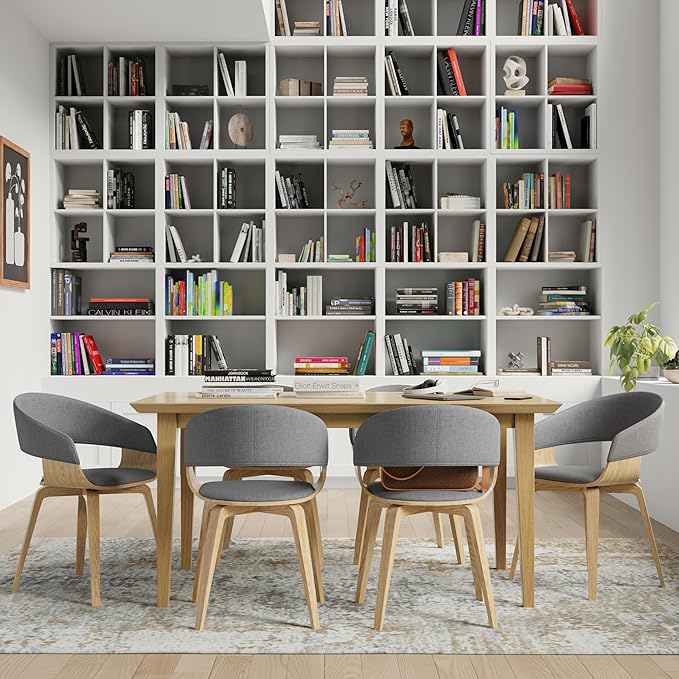 A well-lit dining room showcasing a wooden table surrounded by chairs, creating an inviting space for meals and gatherings.