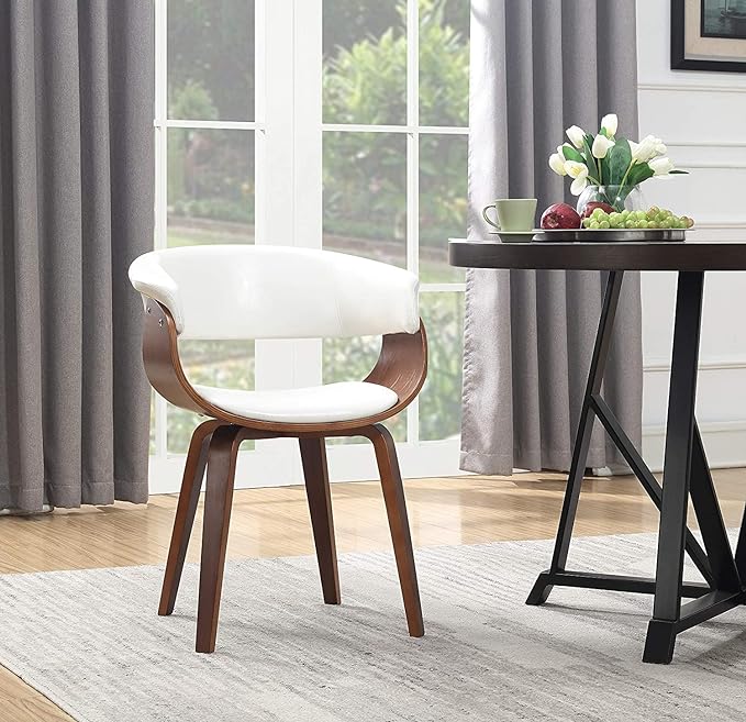 White and wood chair in a room, minimalist design with natural light and green plant in background.