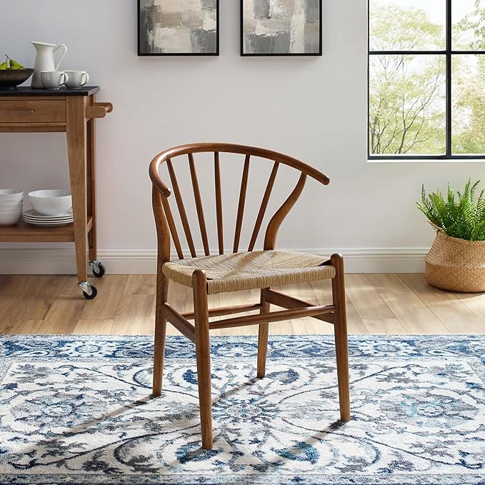 A well-lit dining room showcasing a wooden chair placed in front of a rug