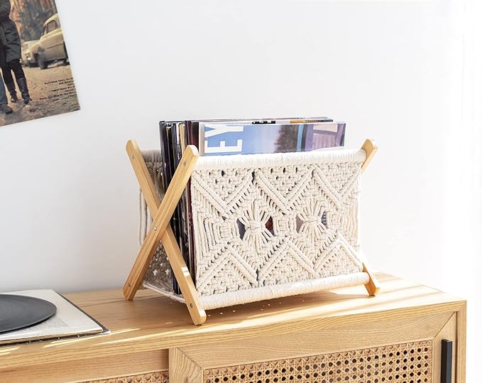 A wooden table with a magazine rack and magazines in it creating a cozy and nostalgic atmosphere.