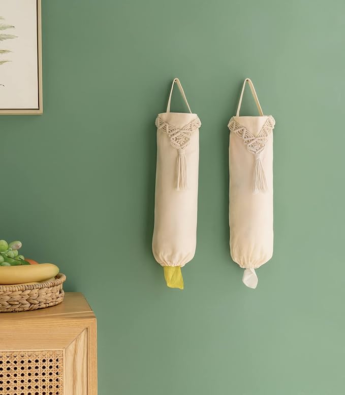 Two cotton plastic bag holders hanging on a wall beside a fruit basket.