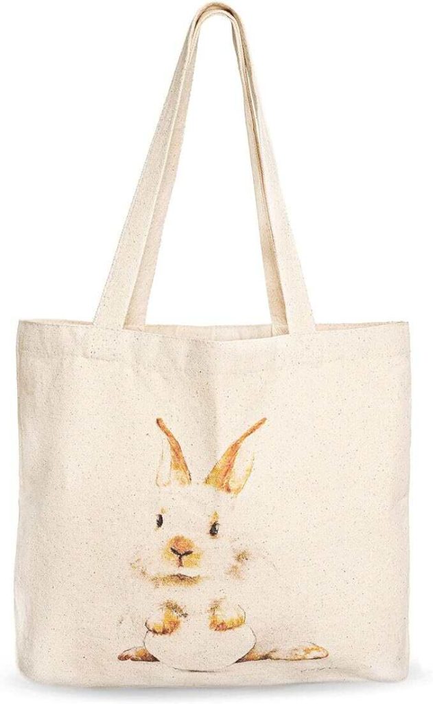 A canvas tote bag with a white rabbit sitting printed on it