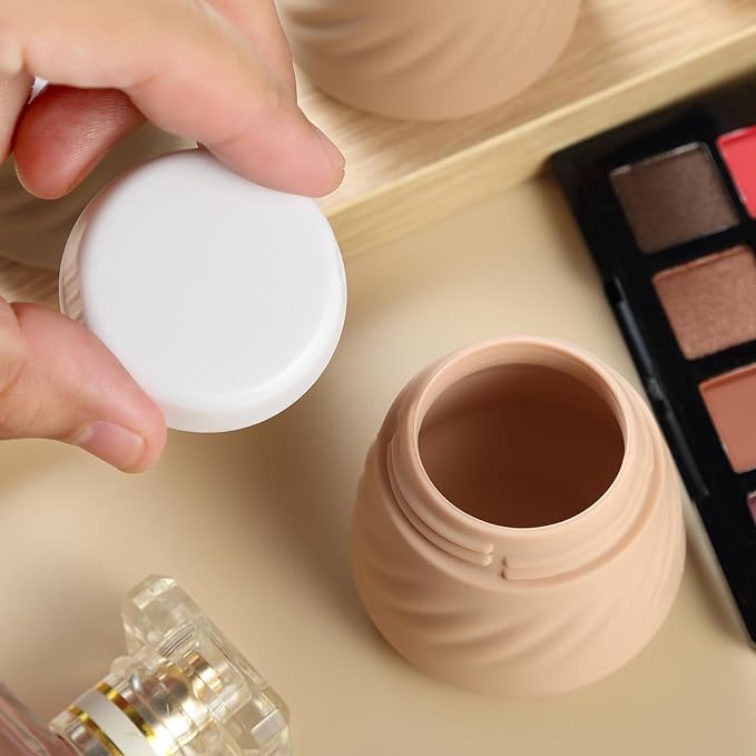 A person holding a small travel silicone container in beige.