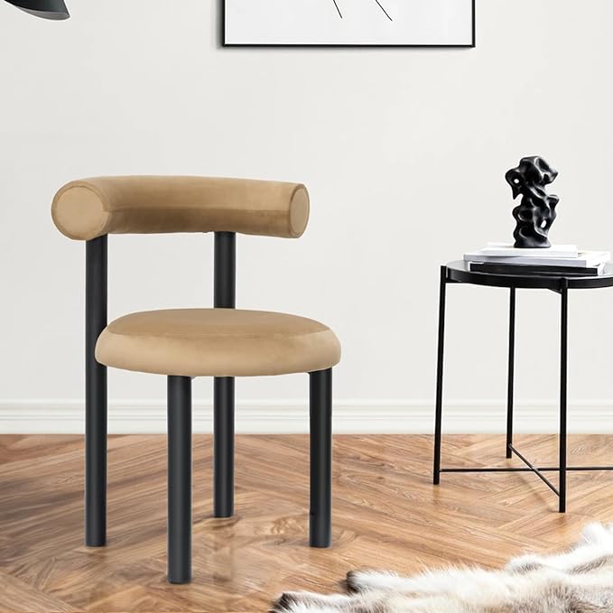 A round brown velvet chair on a wooden floor and a stool