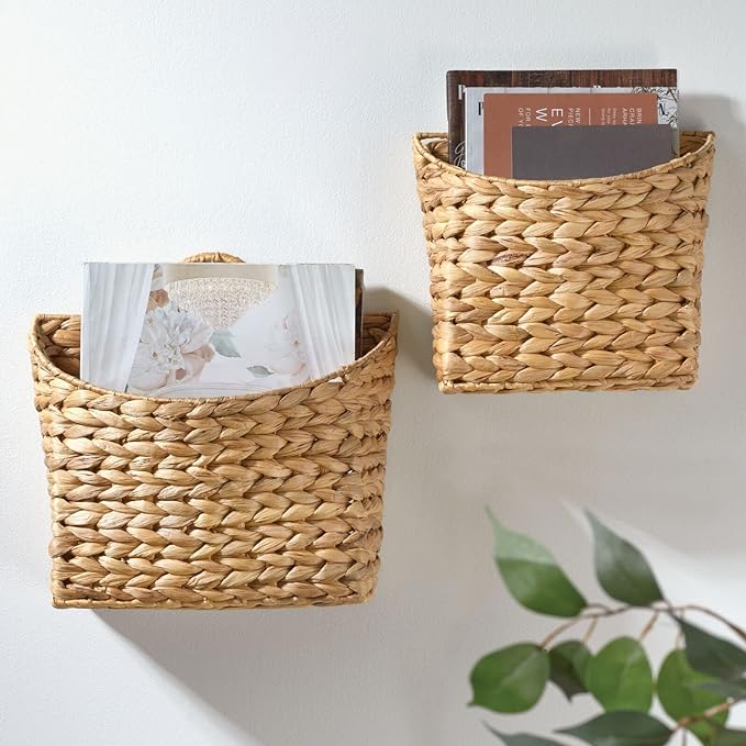 Two wicker baskets on wall filled with magazines.